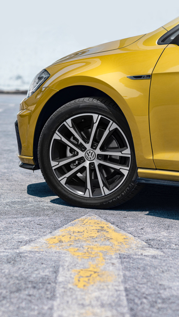 Collage of a woman driving a car with a tire on a gold car